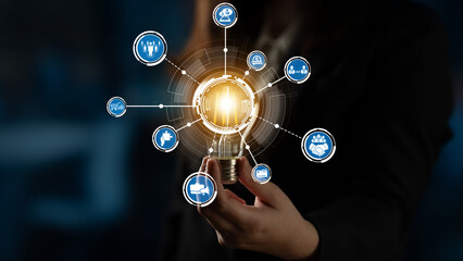 A professional hand holding a glowing light bulb symbolizes ideas and creativity, surrounded by...