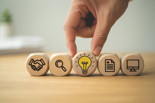Design Thinking Process concept. Wooden blocks with icons; the key stages of the design thinking process, a solution-focused, problem-solving methodology used for innovation and strategic development.