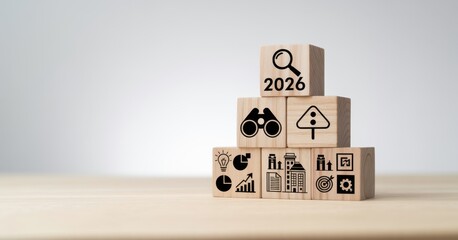 Economic, business outlook concept. Financial, business view or economic growth forecast for 2026. OUTLOOK 2026 text and business trend icons on wooden cube blocks, copy space, minimal background.