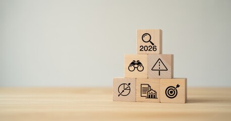 Economic, business outlook concept. Financial, business view or economic growth forecast for 2026. OUTLOOK 2026 text and business trend icons on wooden cube blocks, copy space, minimal background.