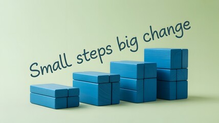 Blue wooden blocks stacked in ascending order with motivational phrase