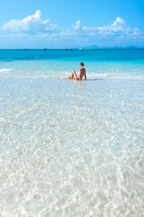 Tropical Thailand - Rear View Woman Relaxing In Shallow Turquoise Sea