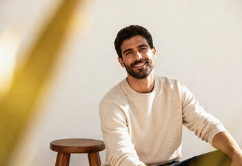 Confident spanish man enjoying the sunlight in a relaxed indoor setting. perfect for lifestyle and marketing designs.