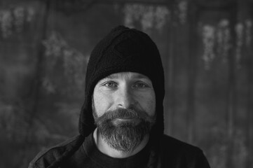 Bearded man wearing black knit hat, authentic portrait with natural light