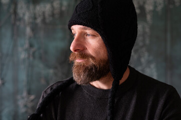 Bearded man wearing black knit hat, authentic portrait with natural light