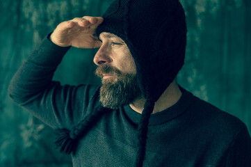 Bearded man wearing black knit hat, authentic portrait with natural light