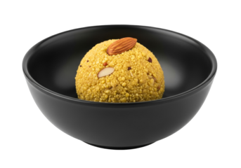 golden besan ladoo in black bowl on white background