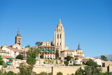 Historic buildings on a hillside under a clear sky.. Segovia, Spain
