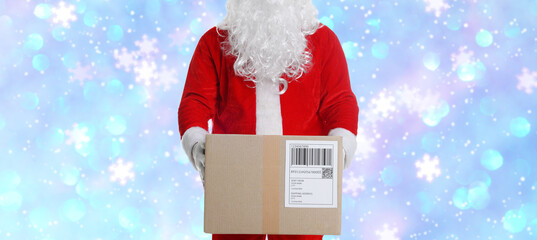 Santa Claus holding parcel on blue gradient background with bokeh lights, closeup. Holiday delivery