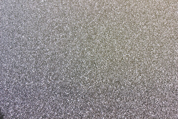 Snow crystals on the ice surface. Flat background.