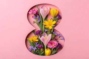 Spring flowers visible through cut pink paper in shape of figure 8. Women's Day celebration