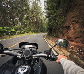 First-person GoPro footage taken from a motorcycle rider's perspective on a winding forest road...