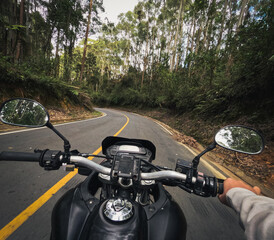 First-person GoPro footage taken from a motorcycle rider's perspective on a winding forest road...