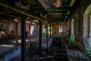 Fototapeta premium Abandoned sugar factory in Italy. Industrial ruins, derelict refinery interior, and urban exploration (urbex) photography
