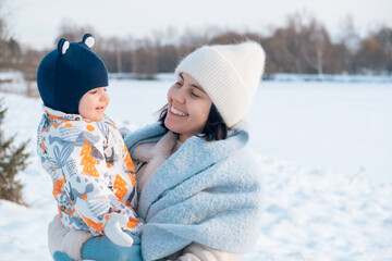 Smiling Mother and Baby Enjoying a Winter Day
