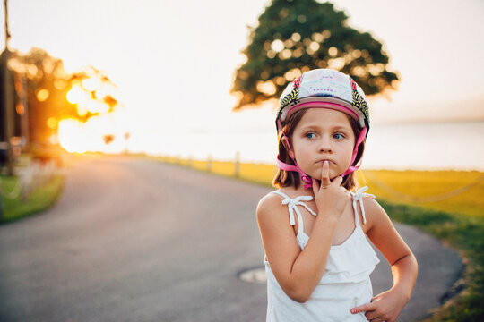 little girl on the road biking helmet