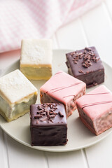 Sweet dessert cake. Mini pie on plate on white table.