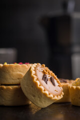 Sweet mini tartlets on black table.