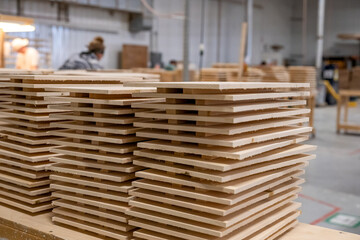 Wood stacks in a busy workshop ready for crafting furniture during the day