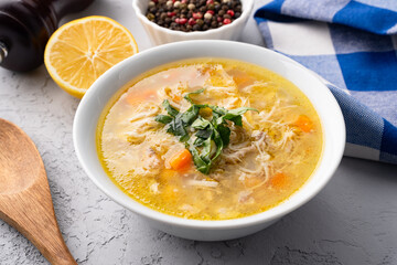 Delicious chicken soup with chickpeas served on an old stone table.	
