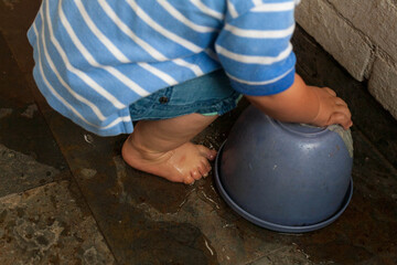 Young toddler playing with water on terrace