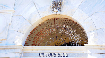 Arch Over Oil and Gas Building Sign