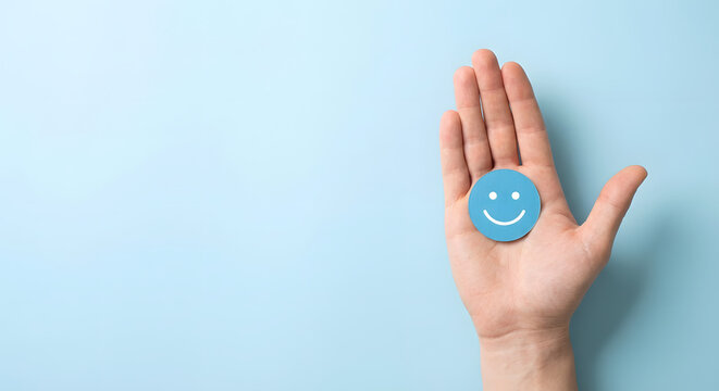 hand with blue smiley face on palm