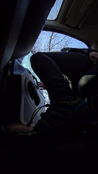 Vertical video of a young woman exiting a taxi car and closing the door on a city street. Urban transportation concept.