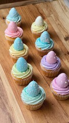 Colorful Easter cupcakes with pastel frosting and decorative egg toppers arranged on a wooden surface. Perfect for spring celebrations and family traditions.