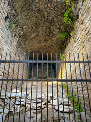 Roman Trajaneum Ruins of Pergamon Featuring Vaulted Stone Corridor with Iron Gate
