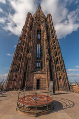Visit to Strasbourg Cathedral with view of clock platform in broad daylight with blue sky