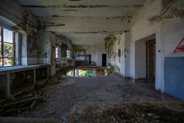 Fototapeta premium Abandoned sugar factory in Italy. Industrial ruins, derelict refinery interior, and urban exploration (urbex) photography