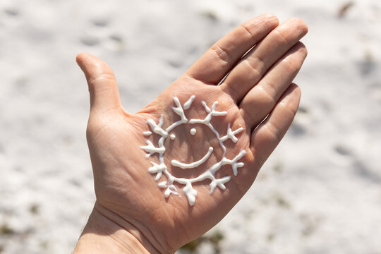 Closeup of a person using the correct amount of sunscreen in winter. 
