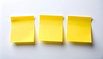 Three yellow sticky notes on clean white background, blank paper surface, minimalist planning