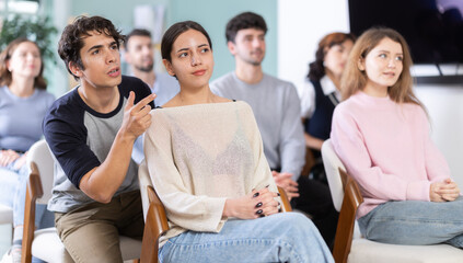Students are in a foreign language speaking club, they practice speaking. Young women and men receive additional education in an educational institution