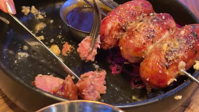 cut barbecue sausages Cutting Grilled Sausages on Plate