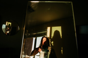 woman holding camera with reflection in mirror