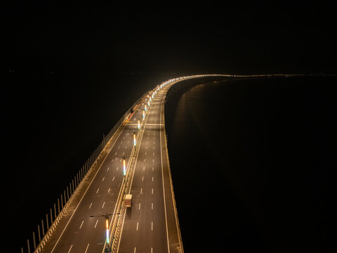 Aerial view of the illuminated Trans-Harbour Link Road slicing through the inky darkness with its radiant string of lights, Mumbai, Maharashtra, India.