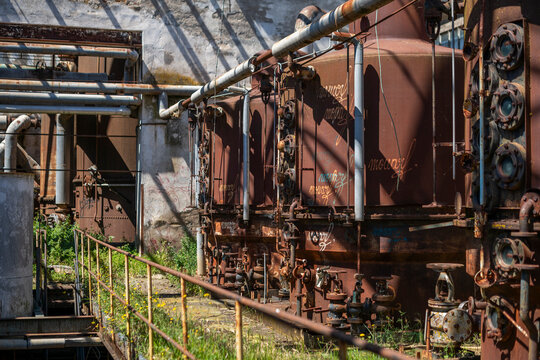 Derelict industrial hall of an abandoned Italian sugar mill. Large warehouse ruins with decaying walls and urban exploration atmosphere - Powered by Adobe