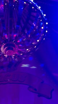 Spotlights and a light show under the circus dome. Bright neon beams illuminate the circus dome.