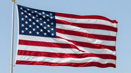 Fototapeta premium American flag waves proudly against a clear blue sky, symbolizing freedom and patriotism