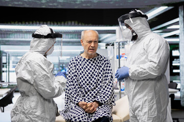 Scientific medics in virology unit monitoring patient for symptoms of infection during epidemic response, conducting laboratory research on vaccines, antibiotics and antiviral therapy.