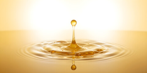 A single drop of golden honey falls into ripples on a yellow-white gradient background with glossy texture.