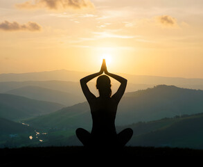 A person sits in meditative pose on hilltop at sunset amidst rolling hills and valleys