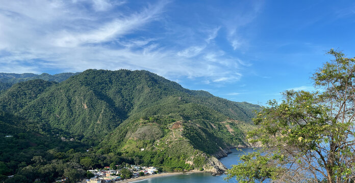 Aerial view of the tropical mountain range and a coastal town by the Caribbean Sea - Chichiriviche de la Costa, La Guaira, Venezuela
