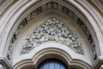 Wesley Memorial Church, a Methodist church in central Oxford. Tympanum above the entrance, decorated with stone carvings. Oxford, United Kingdom.