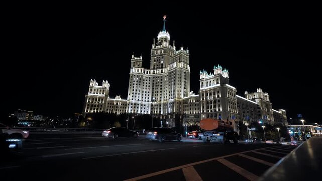 Kotelnicheskaya Embankment Building illuminated at night with city traffic in Moscow