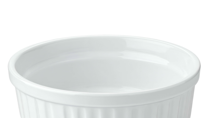 Close-up of a white, round, ceramic ramekin with ridged sides and an empty interior