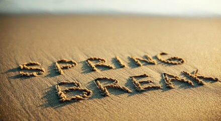 Spring break message written in sand on sunlit beach with soft shadows