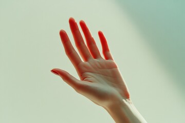 Close-up of a hand with blood on the fingertips reaching out towards the camera.